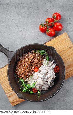 Beef Stroganoff In Cream And Buckwheat And Cherry Tomatoes In Pan