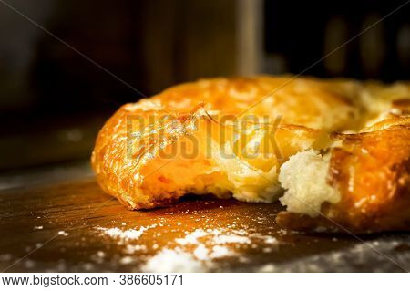 A Broken Turkish Cheese Cake Lies On A Wooden Table. Broken Pita With Cheese On A Vintage Wooden Tab