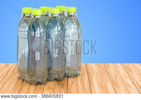 Water Bottles Wrapped In The Shrink Film On The Wooden Table. 3d Rendering