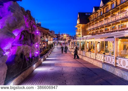 Bialka Tatrzanska, Poland, March 2019 Restaurants And Shopping Area In Ski Lift Bania At Night Time.