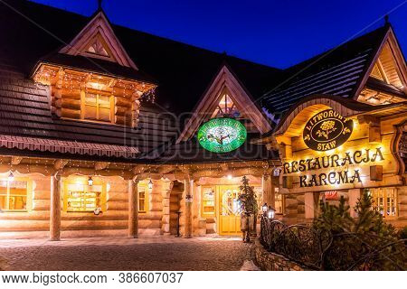 Bialka Tatrzanska, Poland, March 2019 Traditional Polish Wooden Restaurant At Night Time. Popular Wi