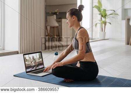 Yoga Teacher Conducting Virtual Yoga Class At Home On A Video Conference. Beautiful Fit Woman Practi