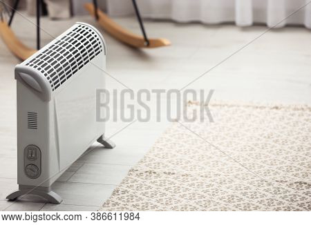 Modern Electric Heater In Stylish Room Interior. Space For Text