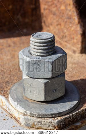 Large Head Bolt On Metal Construction As Background - Engineering Concept. Metal Head Of Bolt Mounte