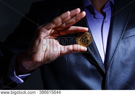 Golden Bitcoin In A Man Hand, Digitall Symbol Of A New Virtual Currency