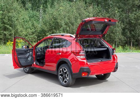Russia, Izhevsk - August 13, 2020: New Modern Subaru Xv Car With Open Car Boot And Open Door Driver.