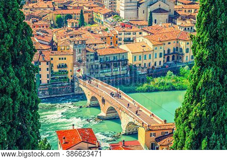 The Ponte Pietra Stone Bridge, Pons Marmoreus, Roman Arch Bridge Across Adige River, Buildings With 