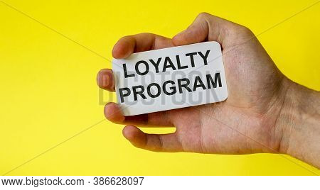 Loyalty Program Card In Hand Isolated On Yellow Background