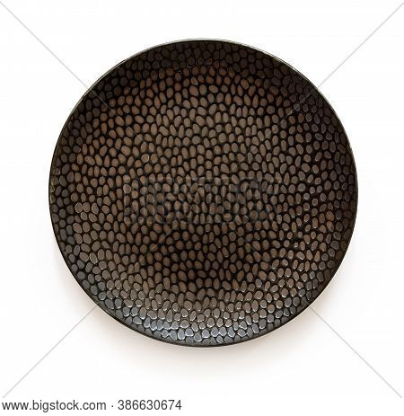 Round Black Ceramic Plate With Textured Surface Isolated On A White Background. Empty Crockery For F