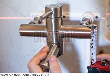 Sanhnik Assembles An Iron Mixer For Water Supply, Using A Laser Level And A Tape Measure. Plumbing I