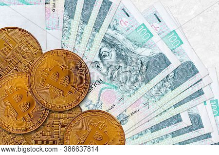 100 Czech Korun Bills And Golden Bitcoins. Cryptocurrency Investment Concept. Crypto Mining Or Tradi