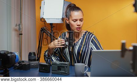 Video Blogger Doing A Comparison Review Of Two V Mount Batteries In Studio. Professional Videography