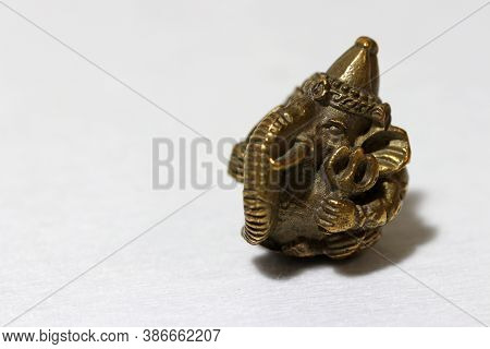 Mini Ganesha Made From Brass On White Background, The Son Of Uma Devi God In Hinduism And Brahmanism