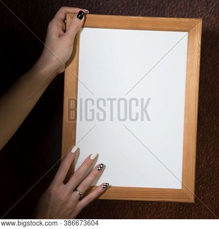 Partial View Of Young Blond Woman Holding Wooden Frame, Dark Background, Mockup, Blank Space