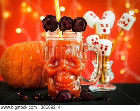 Glass Mug Skull With Red Tomato Juice. A Cocktail At A Halloween Party. Marshmello Scary Faces, Ghos