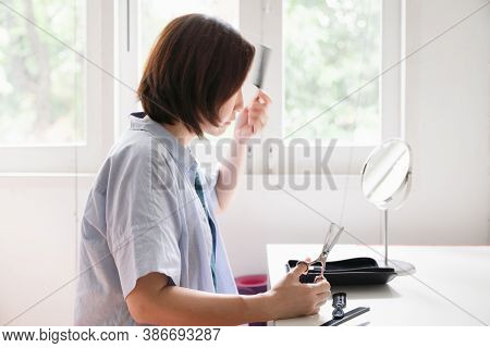 A Motion Blur Of Woman Using Comb On Her Hair During Prepare To  Self Haircut By Scissors At Home Wh