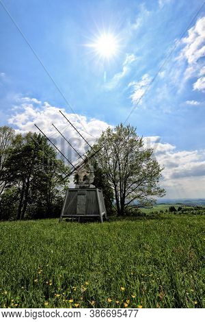Special Antenna Array Radiotelescope Behind The Meadow With Yellow Blossoms And Sun Above