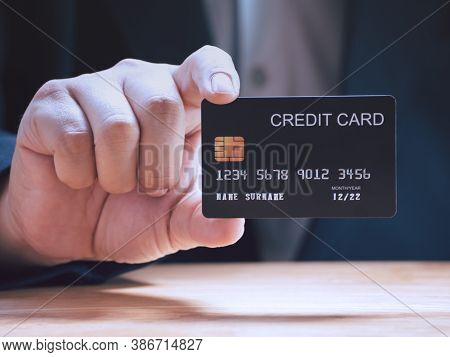 Businessman Holding Or Showing Black Creadit Card For Shopping Online. E-commerce, Commercial, Payme
