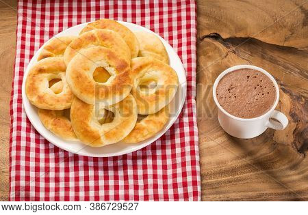 Pandequeso Traditional Colombian Food - Hot Drink Chocolate. Wood Background