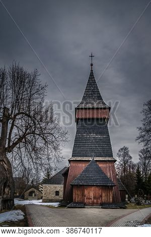 Unique 17th Century Wooden Church In Bialka Tatrzanska. Dark, Moody Storm Clouds And Dramatic Sky. T