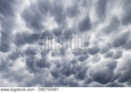 Stormy sky with menacing mammatus clouds before the storm. Climate change nature background