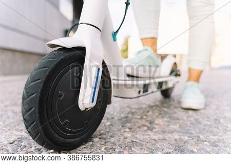 Detail Of An Electric Scooter In An Urban Environment With Blurred Background - Concept Of Sustainab