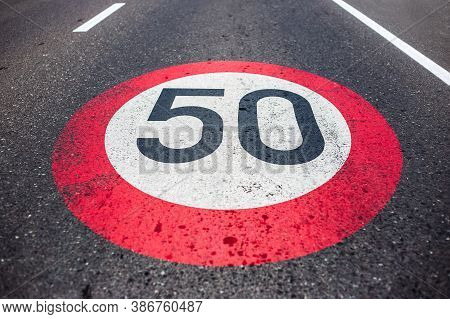 50km/h Speed Limit Sign Painted On Asphalting Road.