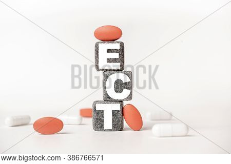 A Group Of White And Red Pills And Cubes With The Word Ect Electroconclusive Therapy On Them, White 
