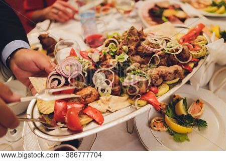 Kebab - Grilled Meat With French Fries And Vegetables On Wooden Background.