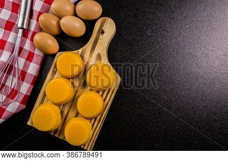 Delicious Quindins On Wooden Board, Traditional Brazilian Dessert Made With Egg Yolk, Sugar And Coco