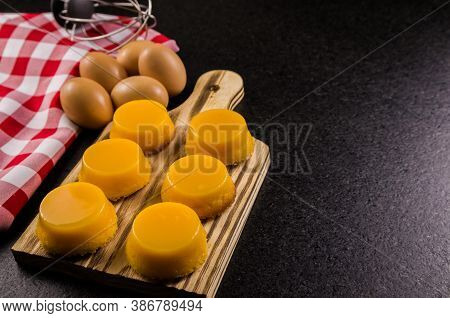 Delicious Quindins On Wooden Board, Traditional Brazilian Dessert Made With Egg Yolk, Sugar And Coco