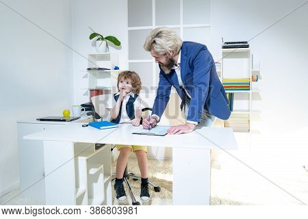Boss And Employee. Little Boss And Mature Employee In The Office. Business People Planning Strategy 