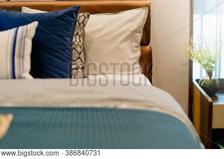 Bed Maid-up With Clean White Pillows And Bed Sheets In Beauty Bedroom. Close-up. Interior Background