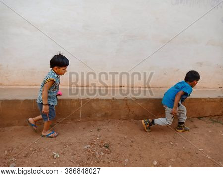 District Katni, India - May 21, 2020: Two Indian Little Kids Playing With Toy Car Together At Open E