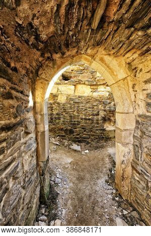 Stony Portal Of The Medieval Entrance With Wall In Background
