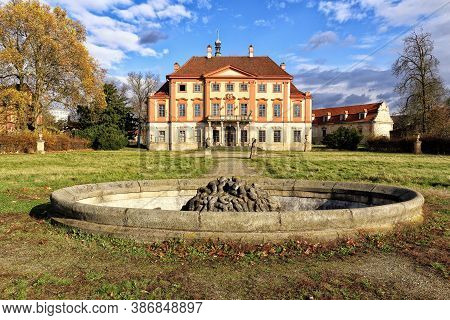 Old Abandoned Libechov Castle Builing With Empty Fountain In Nearby Park