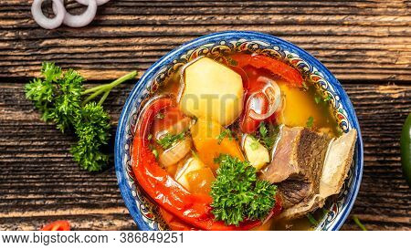 Shurpa Soup In Plate With Oriental Ornament, Wooden Background. Top View. Traditional Asian, Uzbek, 