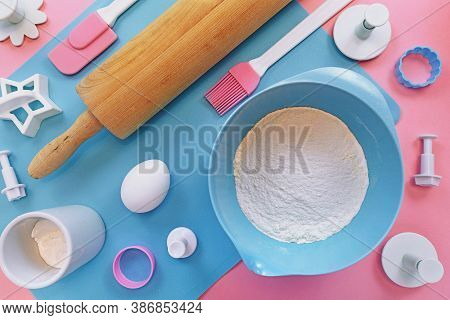 Flat Lay With Cute Pink And Blue Baking Utensils Like Wooden Rolling Pin, Cookie Cutters Or Ingredie