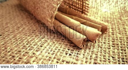 Indian Traditional Bidi Called Cigarette On Brown Sack Mat Background, Pack Of Cigarettes, Close-up 