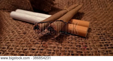 Bidi And Cigarette On Brown Sack Mat Background, Pack Of Cigarettes, Close-up Of A Cigarette