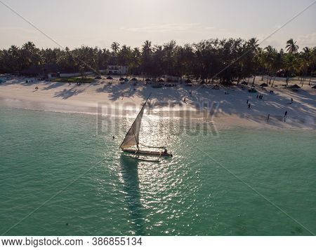 Dhow Catamaran Sail Boat Near The White Sand Beach In Paje Village On Zanzibar