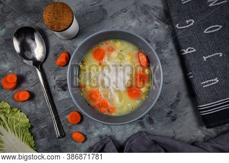 Top View Of Vegan Vegetable Broth Soup With Low Glycemic Asian Sweet Potato Glass Noodles And Carrot