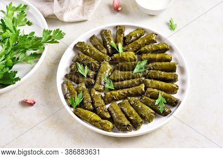 Dolma, Stuffed Grape Leaves With Rice And Meat On Light Stone Background.