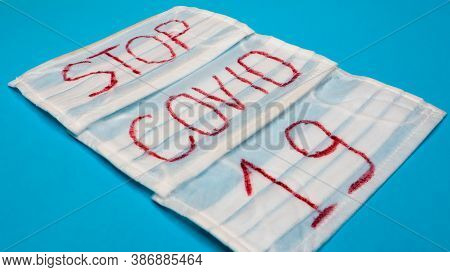 Typical 3-ply White Surgical Mask With Rubber Earhooks To Cover Mouth And Nose With English Block Le