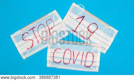 Typical 3-ply White Surgical Mask With Rubber Earhooks To Cover Mouth And Nose With English Block Le