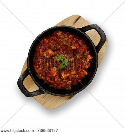 A Traditional Blati Dish Filled With Delicious Balti Chicken Curry, Garnished With A Sprig Of Corria
