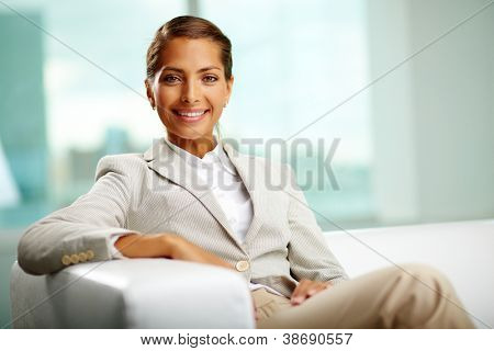 Retrato do sucesso feminino sentado no escritório