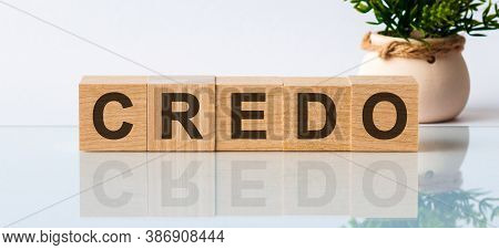 Word Credo. Wooden Small Cubes With Letters Isolated On White Background With Copy Space Available