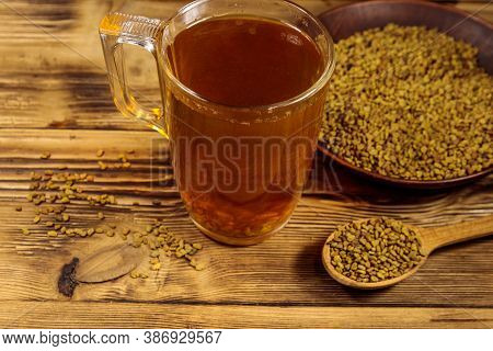 Egyptian Yellow Tea Or Methi Dana Drink And Fenugreek Seeds On Wooden Table