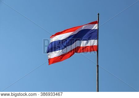 National Flag Of Thailand On Bright Blue Sky Background. Blown Away By Wind. Thailand Is One Of The 